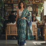 Gen Z woman wearing a sustainable linen saree in a modern pant-style drape with a belt.